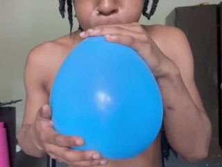 Blowing up balloons while naked