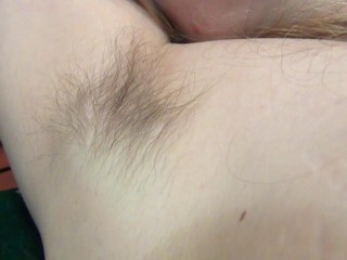 Blonde hairy armpit hair showing in armchair