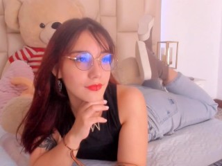 Redhead with glasses makes a living in erotic webcam shows