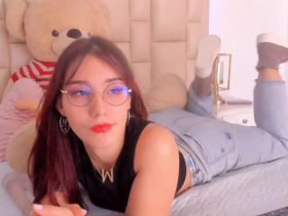 Redhead with glasses makes a living in erotic webcam shows