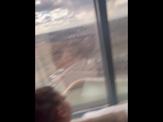 Giving backshots while looking out of 12th story hotel