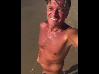 Exhibitionist walks nude on public beach