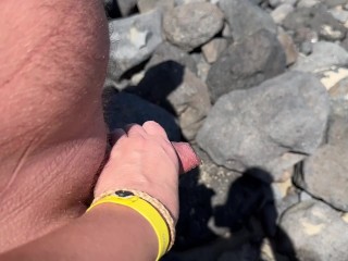 girl helps stranger piss and touches penis On public beach