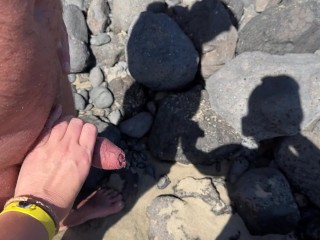 girl helps stranger piss and touches penis On public beach