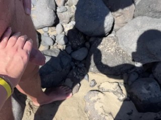 girl helps stranger piss and touches penis On public beach