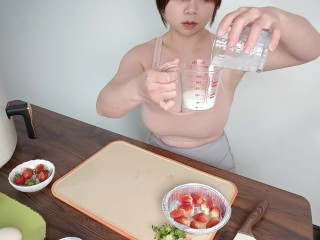 Sexy busty beauty shows off her cooking skills, making strawberry snacks