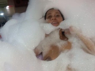 new girlfriend in the tub full of foam, all sexy and naughty, dancing sexy in the motel