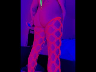 Sissy cross dresser twerks and plays with anal toys in neon Blacklight while watching porn