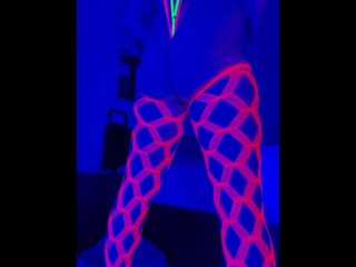 Sissy cross dresser twerks and plays with anal toys in neon Blacklight while watching porn