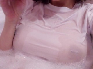 having fun in the bathtub with foam in a wet white top. I smoke and listen to 2rbina2rists