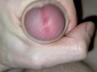 The man jerks his throbbing cock and pulls his balls. Looking at the little pussy cumming.