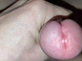 The man jerks his throbbing cock and pulls his balls. Looking at the little pussy cumming.