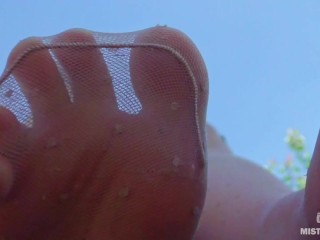 Sexy feet in nylon knee socks and dirty white socks teasing you closeup outdoor