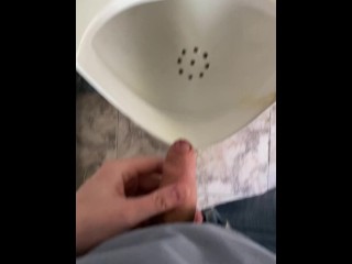 Guy pees in a public toilet POV