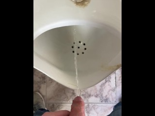 Guy pees in a public toilet POV