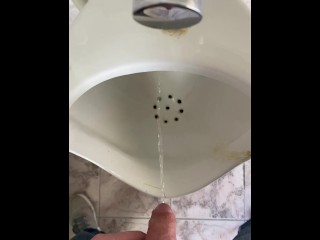 Guy pees in a public toilet POV