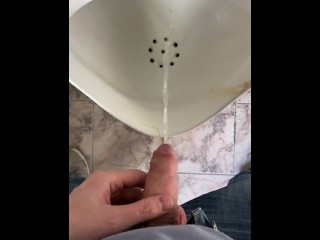 Guy pees in a public toilet POV