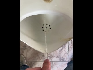 Guy pees in a public toilet POV