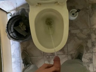 Long pissing of an uncircumcised penis in a public toilet POV