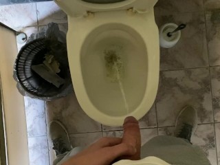 Long pissing of an uncircumcised penis in a public toilet POV