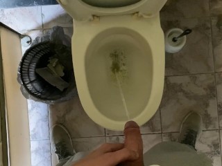 Long pissing of an uncircumcised penis in a public toilet POV