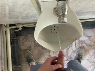 Guy pees in office toilet POV