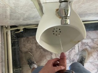 Guy pees in office toilet POV