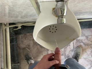 Guy pees in office toilet POV