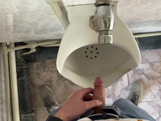 Guy pees in office toilet POV