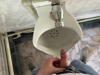 Guy pees in office toilet POV
