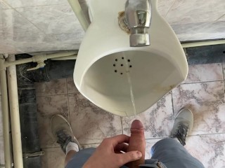 Guy pees in office toilet POV