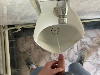 Guy pees in office toilet POV