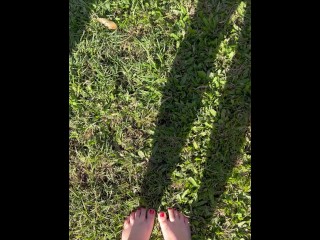 Pretty feet walking barefoot in the grass