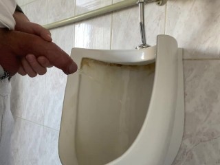 Guy pees with big uncut dick in public toilet