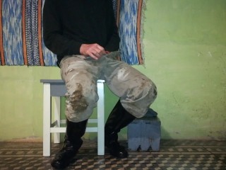 Farm man takes care of his rubber boots at the end of the day