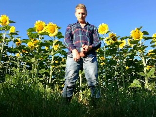 Farm man in rubber boots peeing and masturbating in the sunflower field