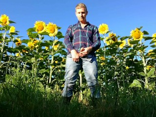 Farm man in rubber boots peeing and masturbating in the sunflower field