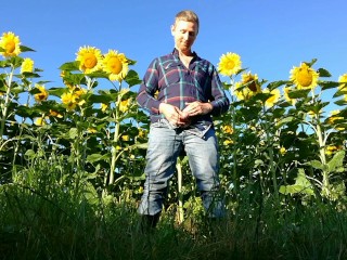 Farm man in rubber boots peeing and masturbating in the sunflower field