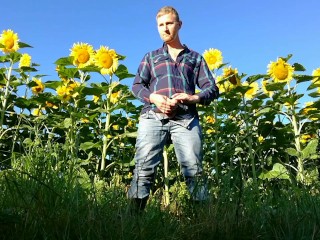 Farm man in rubber boots peeing and masturbating in the sunflower field