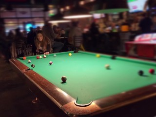 Braless tits and pussy exposed at the pool hall!