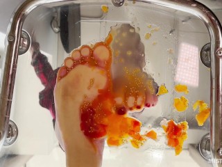 Crush cherry tomatoes with bare feet POV on your face