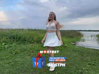 Beautiful babe in white skirt gives blowjob to friend on walk by pond