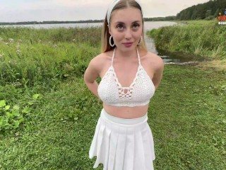 Beautiful babe in white skirt gives blowjob to friend on walk by pond