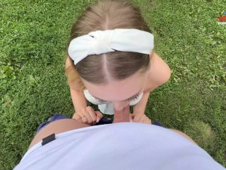 Beautiful babe in white skirt gives blowjob to friend on walk by pond