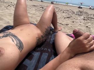 Nudist couple fingering on public beach