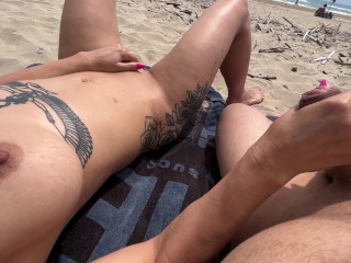 Nudist couple fingering on public beach