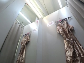 I try on clothes in the fitting room.