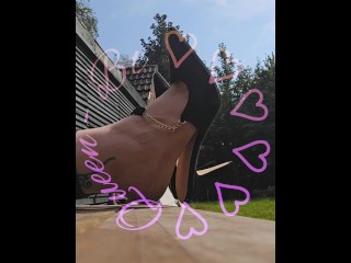 Clapping and dangling my hight heels in the sun.