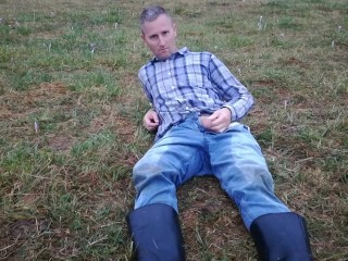 Rubber boots farmer pee in his pissy pants and plays with his cock on the meadow