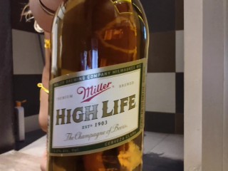 Sissy in micro bikini drinking 1l of beer via anal and then pushing it out